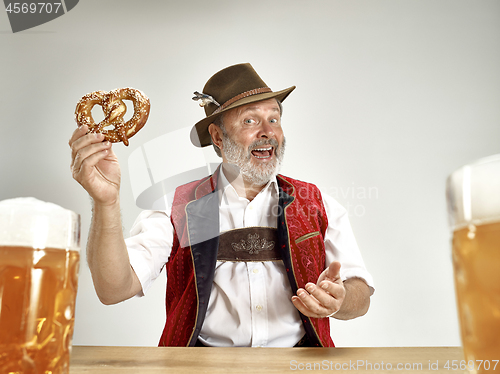 Image of Germany, Bavaria, Upper Bavaria, man with beer dressed in traditional Austrian or Bavarian costume