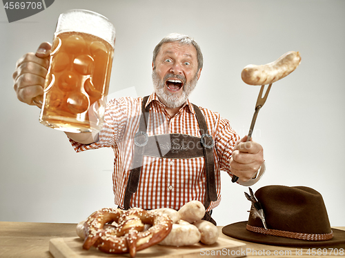 Image of Germany, Bavaria, Upper Bavaria, man with beer dressed in traditional Austrian or Bavarian costume