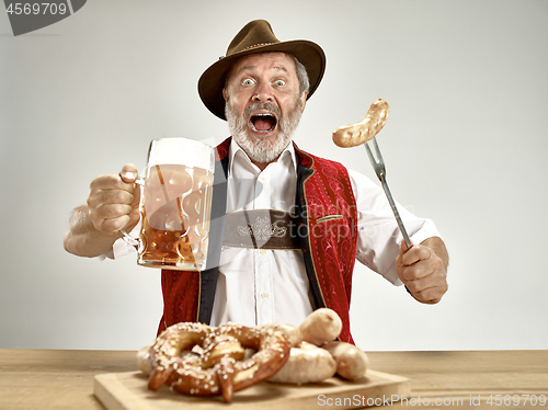 Image of Germany, Bavaria, Upper Bavaria, man with beer dressed in traditional Austrian or Bavarian costume