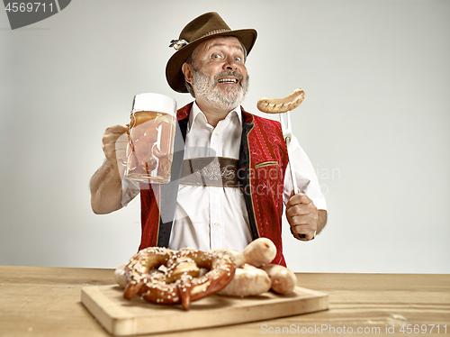 Image of Germany, Bavaria, Upper Bavaria, man with beer dressed in traditional Austrian or Bavarian costume