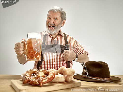 Image of Germany, Bavaria, Upper Bavaria, man with beer dressed in traditional Austrian or Bavarian costume