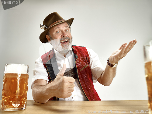 Image of Germany, Bavaria, Upper Bavaria, man with beer dressed in traditional Austrian or Bavarian costume