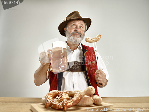 Image of Germany, Bavaria, Upper Bavaria, man with beer dressed in traditional Austrian or Bavarian costume