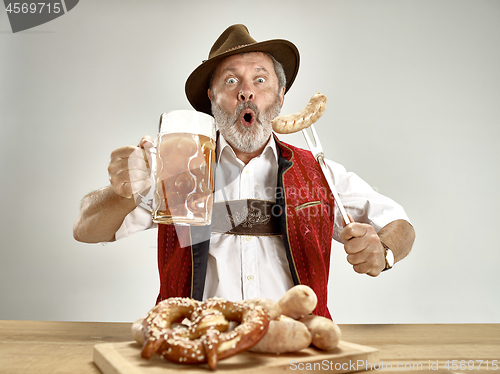 Image of Germany, Bavaria, Upper Bavaria, man with beer dressed in traditional Austrian or Bavarian costume
