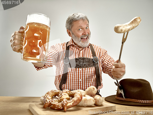 Image of Germany, Bavaria, Upper Bavaria, man with beer dressed in traditional Austrian or Bavarian costume