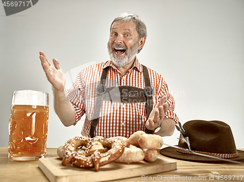 Image of Germany, Bavaria, Upper Bavaria, man with beer dressed in traditional Austrian or Bavarian costume