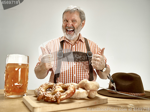 Image of Germany, Bavaria, Upper Bavaria, man with beer dressed in traditional Austrian or Bavarian costume