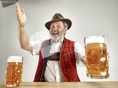 Image of Germany, Bavaria, Upper Bavaria, man with beer dressed in traditional Austrian or Bavarian costume