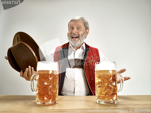 Image of Germany, Bavaria, Upper Bavaria, man with beer dressed in traditional Austrian or Bavarian costume