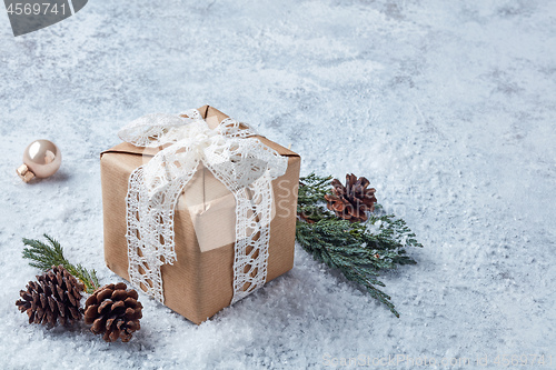 Image of christmas gift on snowy background