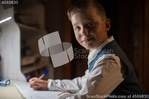 Image of pupil boy does his homework