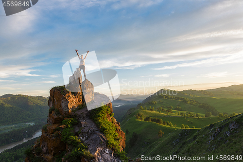 Image of Happy woman on top mountain