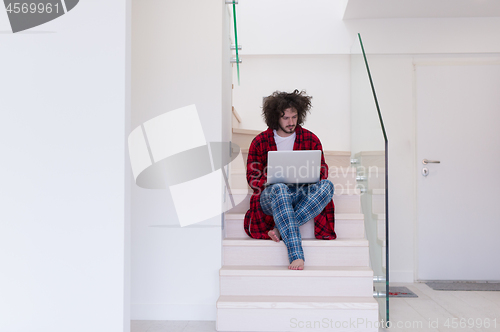 Image of freelancer in bathrobe working from home
