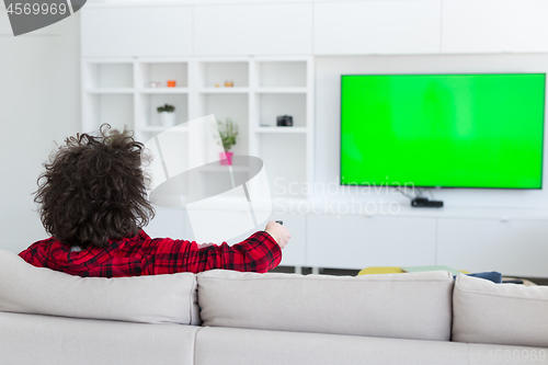 Image of young man in bathrobe enjoying free time