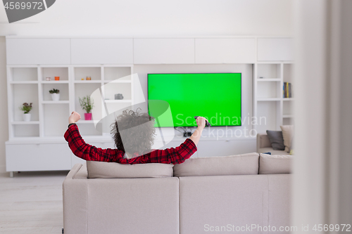 Image of young man in bathrobe enjoying free time