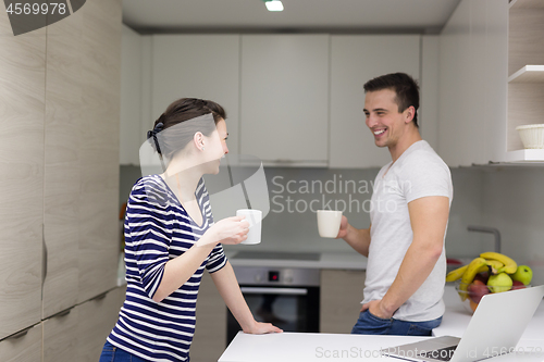 Image of couple with laptop computer enjoying morning