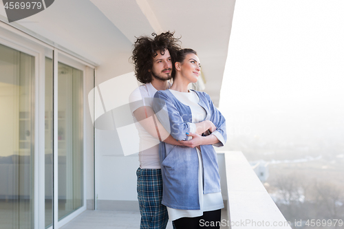 Image of Couple hugging on the balcony