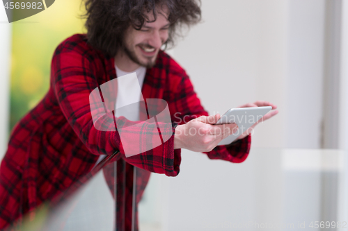 Image of young freelancer using tablet computer