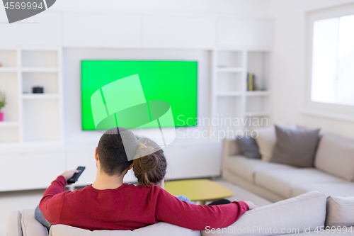 Image of Young couple on the sofa watching television