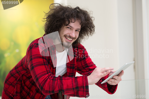 Image of young freelancer using tablet computer