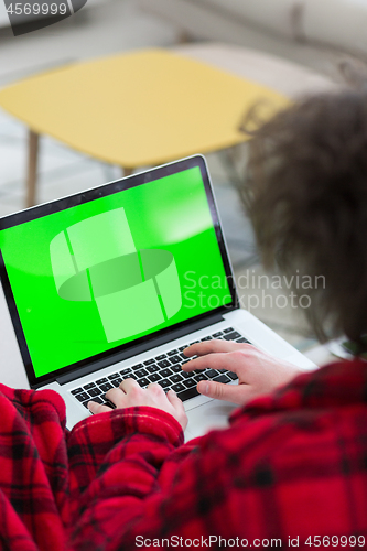 Image of man freelancer in bathrobe working from home