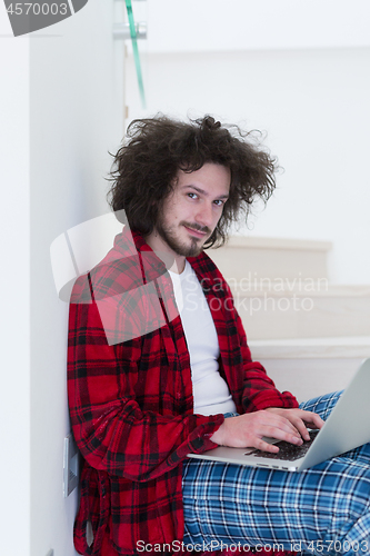 Image of freelancer in bathrobe working from home