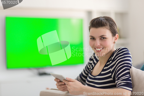 Image of woman on sofa using tablet computer