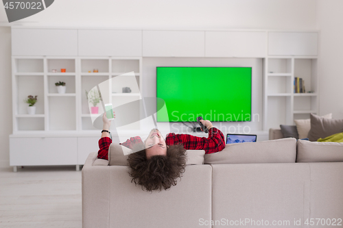 Image of young man in bathrobe enjoying free time