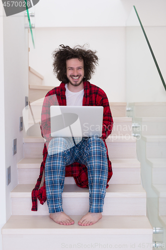 Image of freelancer in bathrobe working from home