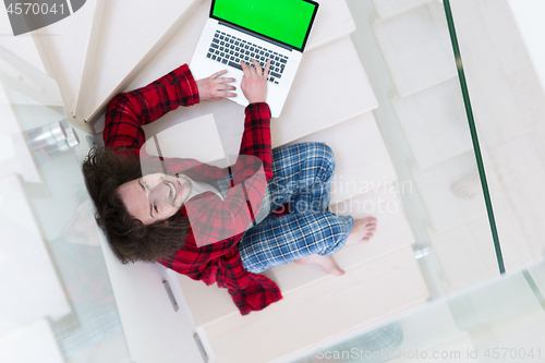 Image of freelancer in bathrobe working from home