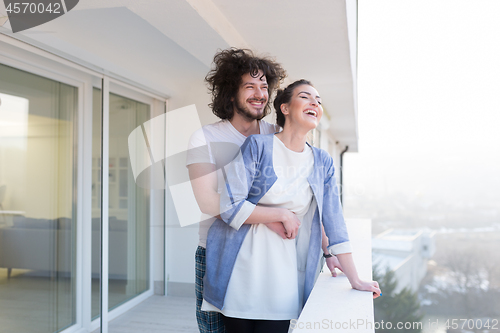 Image of Couple hugging on the balcony