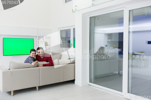 Image of couple hugging and relaxing on sofa