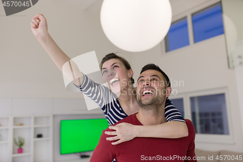 Image of handsome man piggybacking his girlfriend