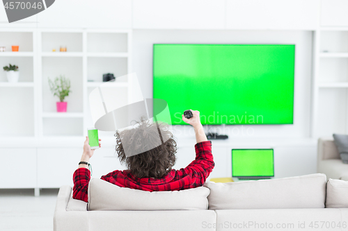 Image of young man in bathrobe enjoying free time