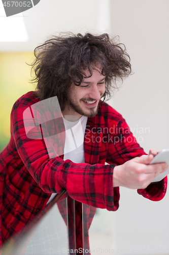 Image of young freelancer using tablet computer