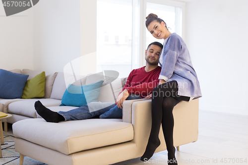 Image of couple hugging and relaxing on sofa