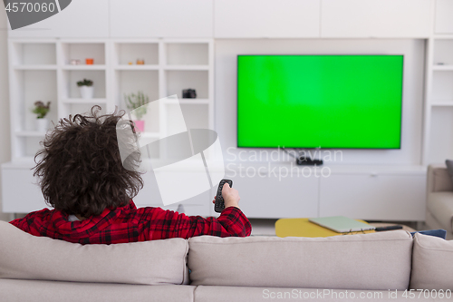 Image of young man in bathrobe enjoying free time