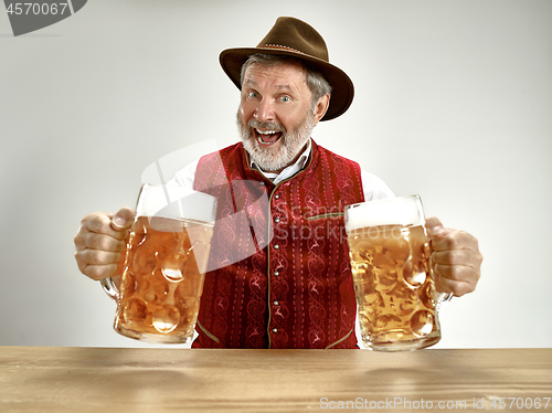 Image of Germany, Bavaria, Upper Bavaria, man with beer dressed in traditional Austrian or Bavarian costume