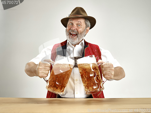 Image of Germany, Bavaria, Upper Bavaria, man with beer dressed in traditional Austrian or Bavarian costume