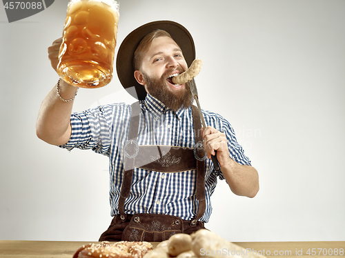 Image of Germany, Bavaria, Upper Bavaria, man with beer dressed in traditional Austrian or Bavarian costume