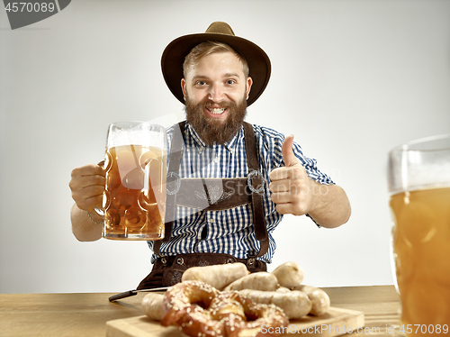 Image of Germany, Bavaria, Upper Bavaria, man with beer dressed in traditional Austrian or Bavarian costume