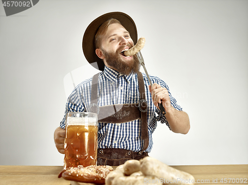 Image of Germany, Bavaria, Upper Bavaria, man with beer dressed in traditional Austrian or Bavarian costume