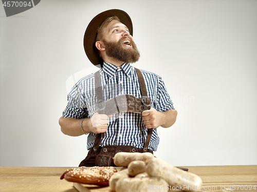 Image of Germany, Bavaria, Upper Bavaria, man with beer dressed in traditional Austrian or Bavarian costume