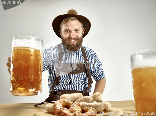 Image of Germany, Bavaria, Upper Bavaria, man with beer dressed in traditional Austrian or Bavarian costume