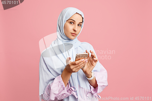 Image of Happy arab woman in hijab. Portrait of smiling girl, posing at studio background