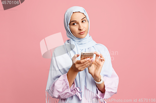 Image of Happy arab woman in hijab. Portrait of smiling girl, posing at studio background