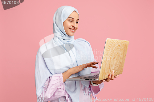 Image of Happy arab woman in hijab. Portrait of smiling girl, posing at studio background