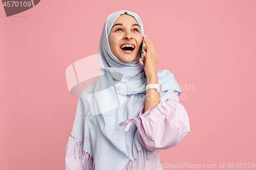 Image of Happy arab woman in hijab. Portrait of smiling girl, posing at studio background