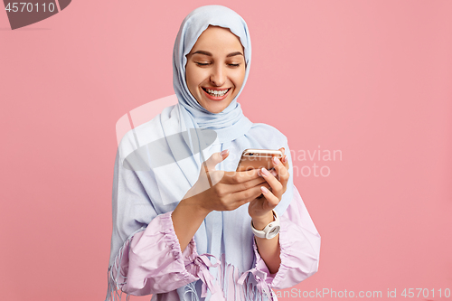 Image of Happy arab woman in hijab. Portrait of smiling girl, posing at studio background