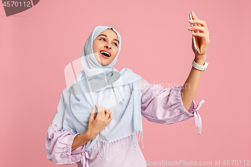 Image of Happy arab woman in hijab. Portrait of smiling girl, posing at studio background